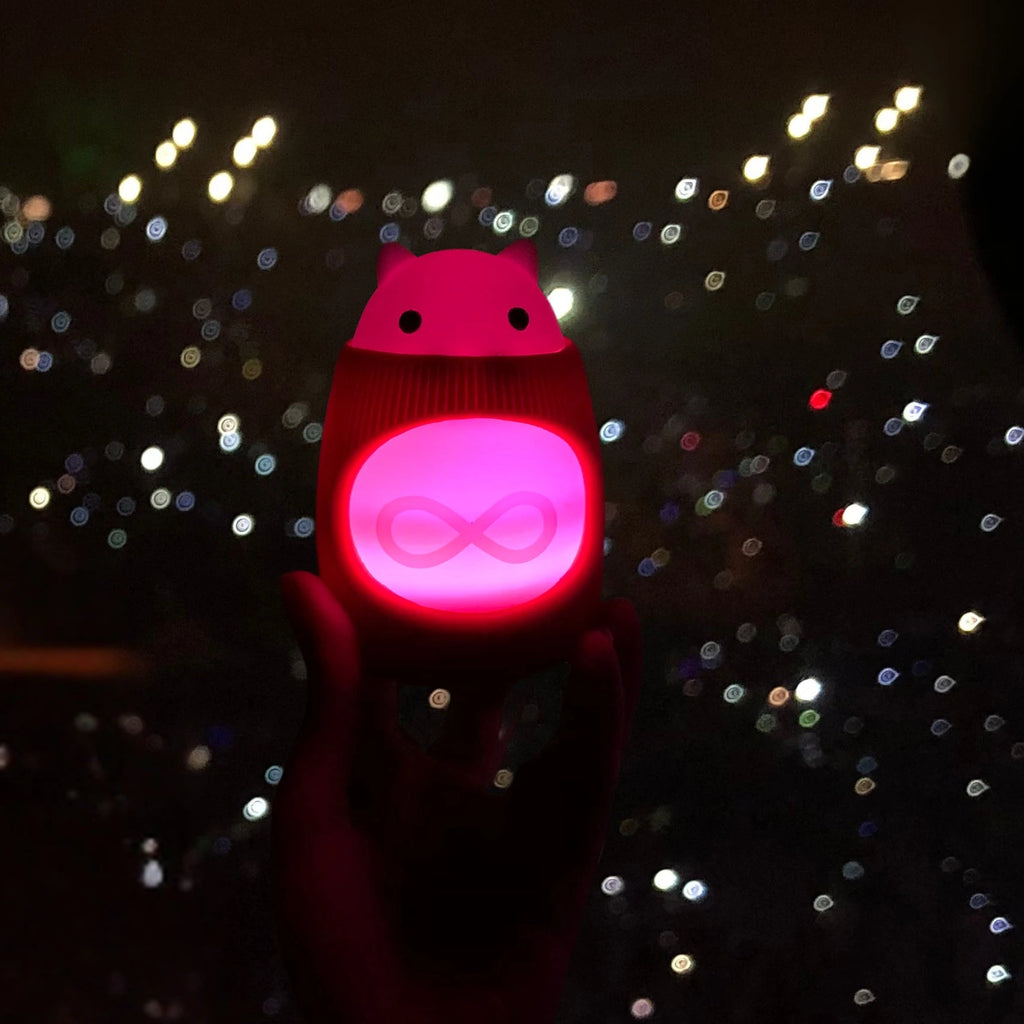 TukToro glows a warm red in a sea of flashlights